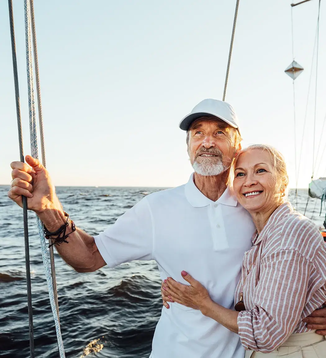 service-card-wealth-management Smiling retired couple on sailboat enjoying financial freedom with BKC wealth management