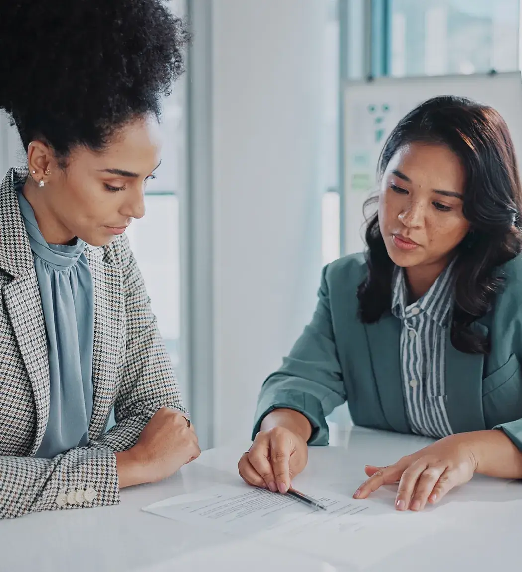 value-risk-service-card Advisor reviewing risk and valuation documents with client